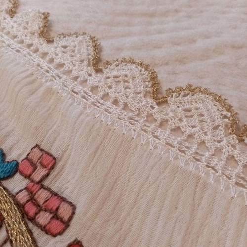 Handmade old embroidery painted and hand-stitched with lace