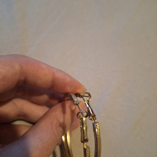 Large gold hoop earrings used with embossed texture