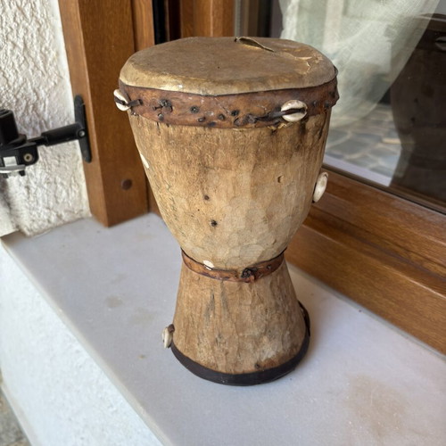 Handmade wooden drum used, African style with leather membrane and shells