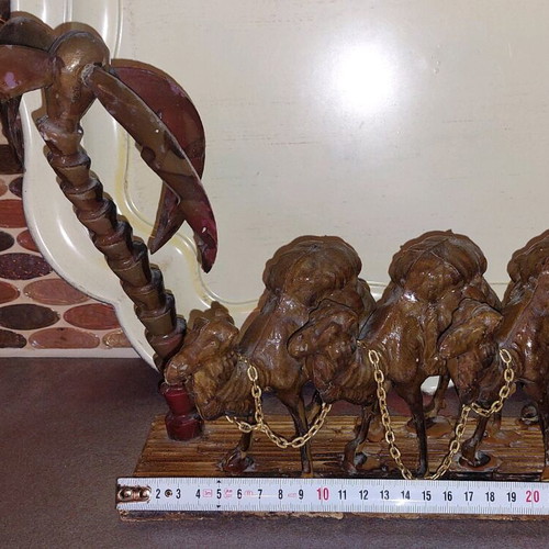 Decorative item used with camels and palm tree made of wood and plastic