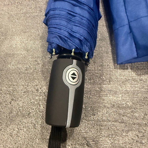 Blue folding umbrella branded with NIKMI AD new