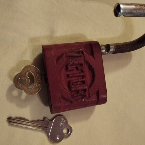 Old padlock used with key and skeleton key