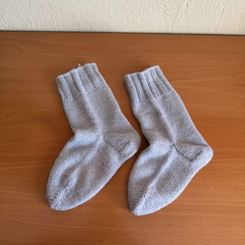 Handmade woolen socks in soft light blue color, new