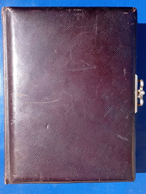 Photo album used with leather cover and metal clasp