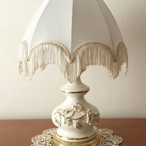Vintage porcelain table lamp with fabric white shade and fringes used