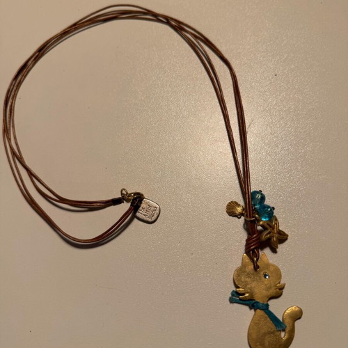 Cat design necklace like new, double brown leather cord with blue beads