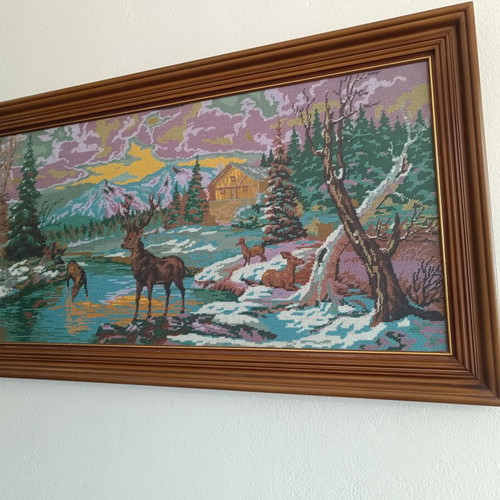 Handmade cross-stitch embroidery in wooden frame, used