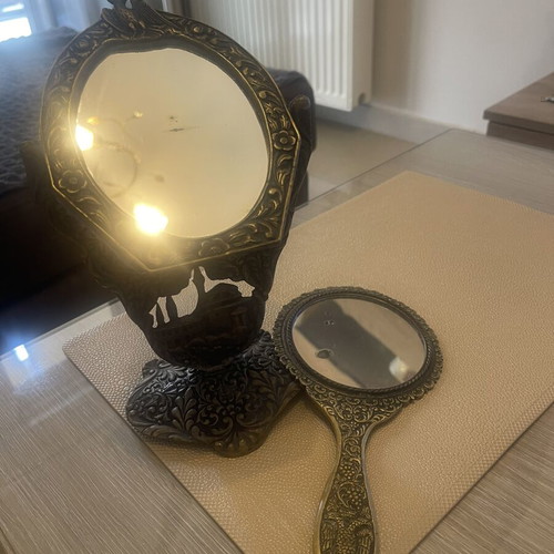 Set of two brass mirrors, table and hand used