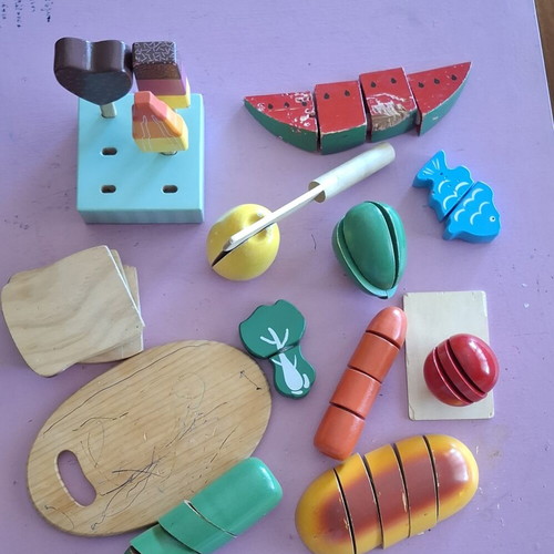 Wooden play food set used with cutting board