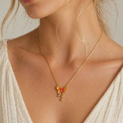 Gold necklace with butterfly, like new, orange accents