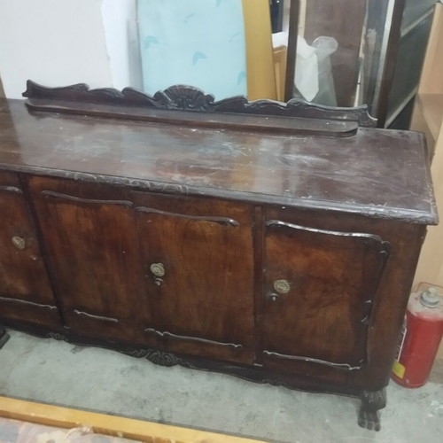 Wooden antique buffet used with carved details and brass handles