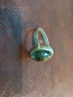Silver women's ring used with pale green stone