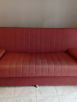 Three-seater sofa bed with storage space