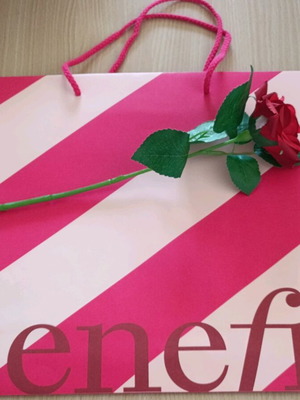 Benefit paper bag with artificial red rose new