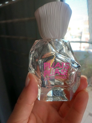 Glass bottle of branded perfume used, empty