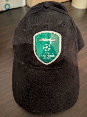 Black jockey hat with Heineken UEFA Champions League shield
