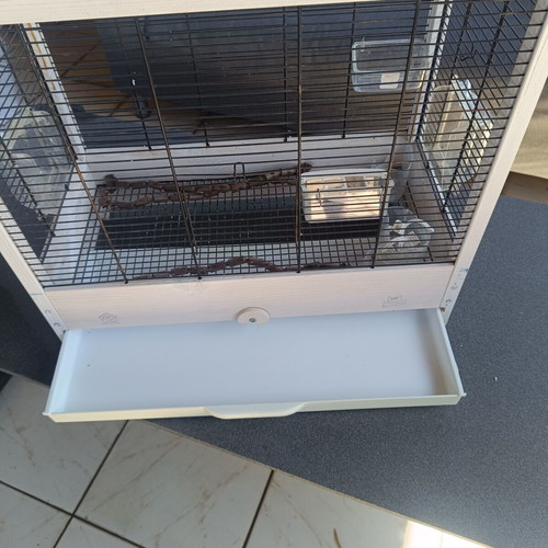 Wooden birdcage used with steel bars and plastic door