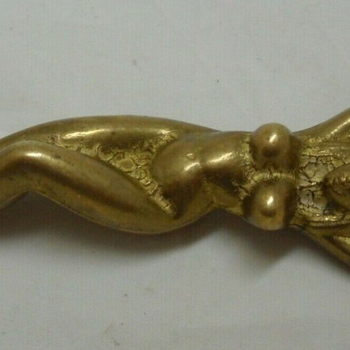 Vintage solid brass bottle opener shaped like a woman used