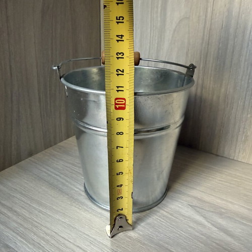 Decorative galvanized metal bucket with wooden handle