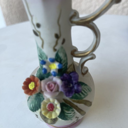 Vintage ceramic pitcher with embossed flowers used