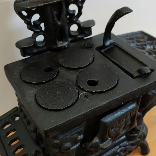 Miniature wooden stove with cast iron accessories like new