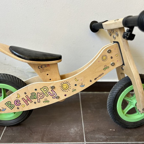 Wooden children's balance bike with extra rear wheel