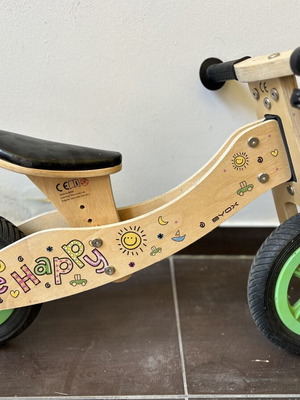 Wooden children's balance bike with extra rear wheel