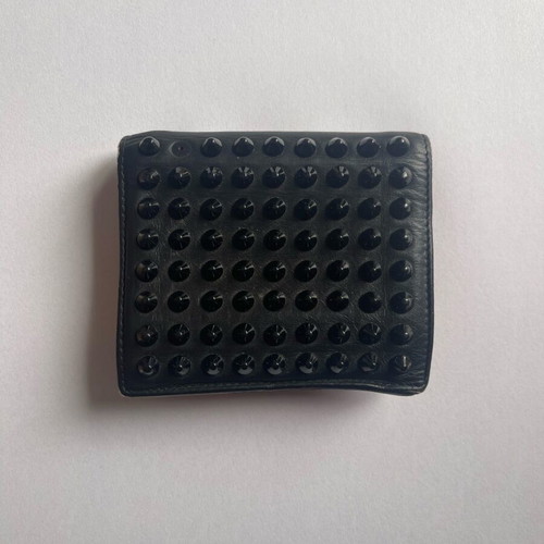 Christian Louboutin wallet used with missing spike and black stains