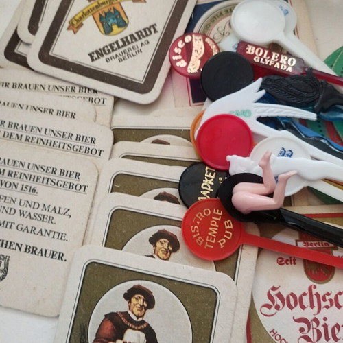 Vintage bar collection with mini liquor bottles, coasters, and stirrers