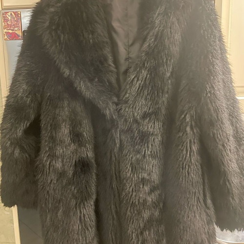 Long-haired fur used, black synthetic with pockets