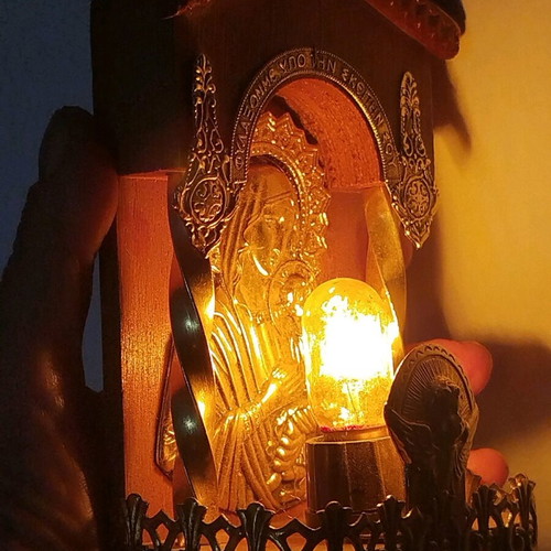 Vintage illuminated icon of Virgin Mary and Christ Child with lamp