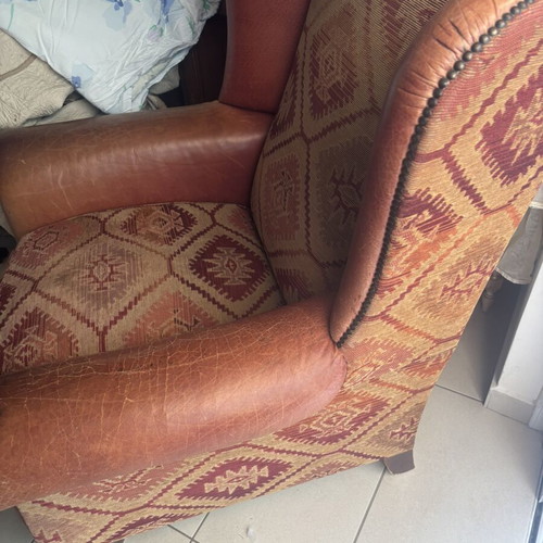 Kourtis armchair used with leather arms in brown tones
