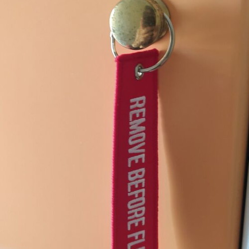 Remove Before Flight keychain new, red