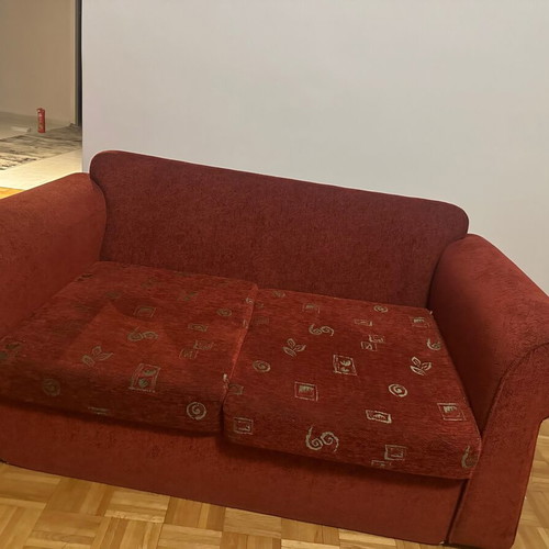 Two-seater sofa used red in good condition