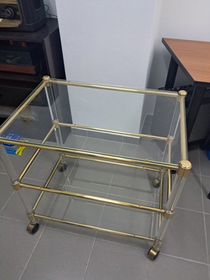 Glass coffee table with wheels, gold color