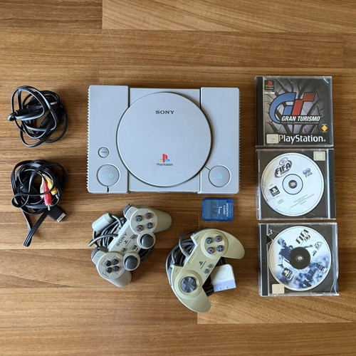 Sony PlayStation 1 console used with 2 controllers, memory card, and 3 games