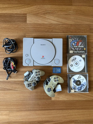 Sony PlayStation 1 console used with 2 controllers, memory card, and 3 games
