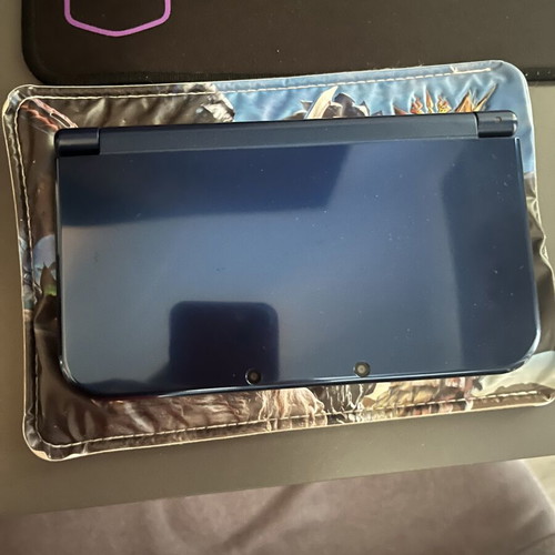 Nintendo 3DS New XL console with charger and Monster Hunters case