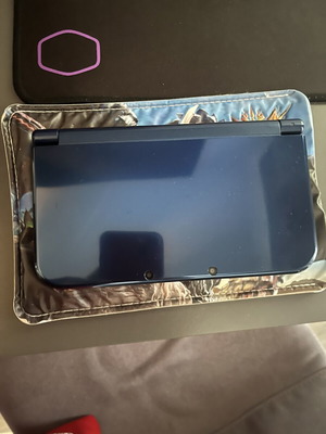 Nintendo 3DS New XL console with charger and Monster Hunters case