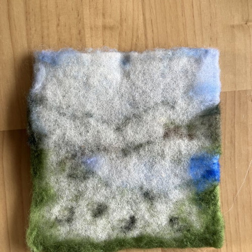 Handmade wool felt landscape picture with sheep