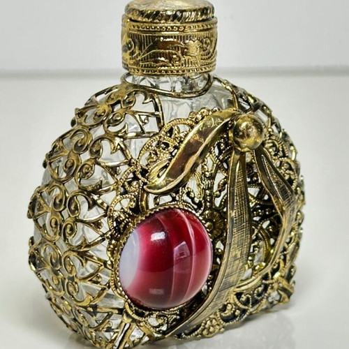 Vintage perfume flacon with filigree metalwork and red cabochon
