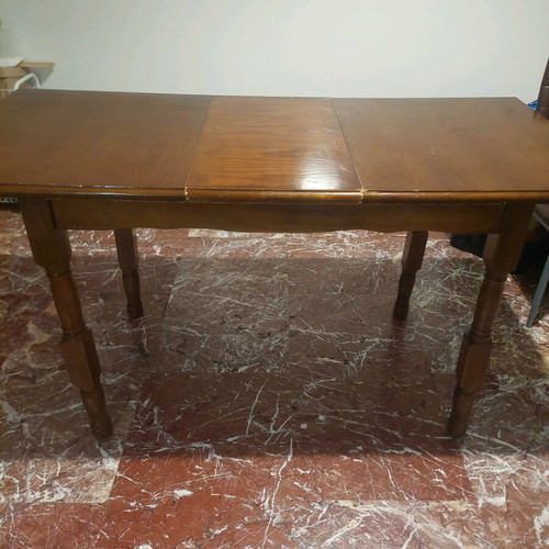 Wooden dining table with extension used