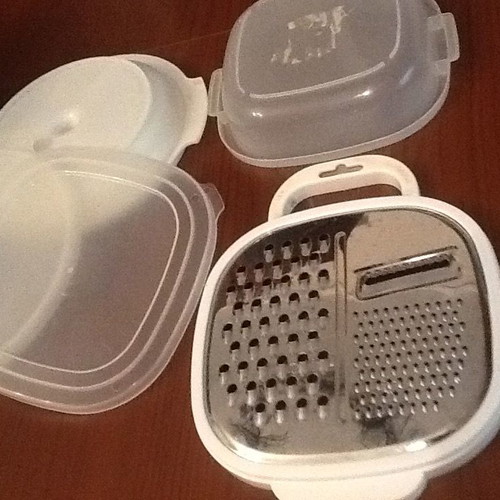 Set of three kitchen containers and stainless steel grater