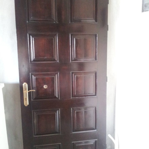 Wooden exterior door with a height of 2:13 × 1 meter wide.