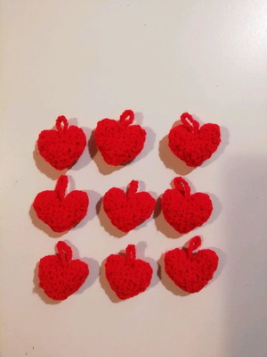 Knitted hanging red hearts like new