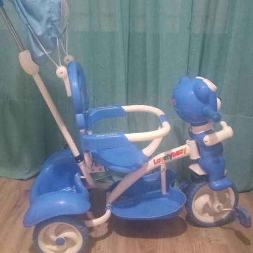Baby blue tricycle used with canopy, storage, and adjustable parent handle