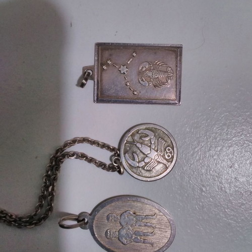 Silver pendant necklace used with zodiac and catholic figures