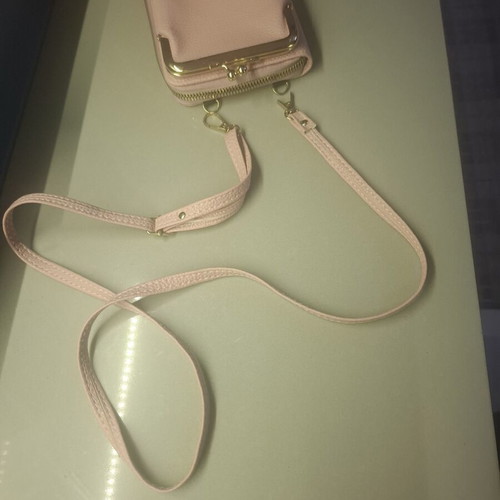 Pink wallet with strap and multiple compartments