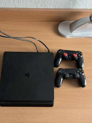 PS4 Slim 1TB console used with 2 controllers and 12 games