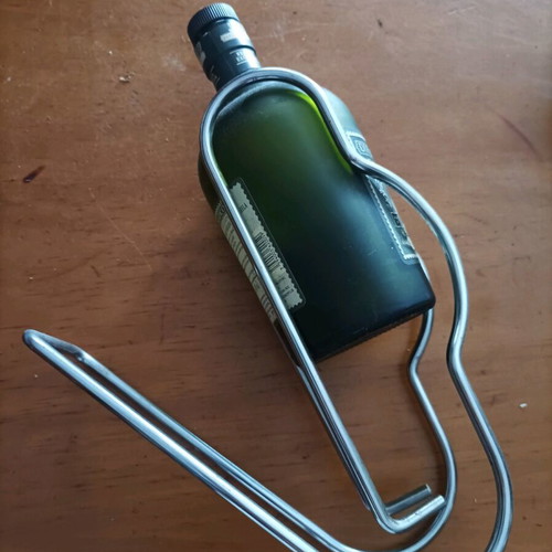 Bottle holder stainless like new with collectible rum bottle